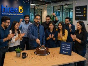 Hireo team celebrating success with founder cutting cake in office, employees clapping in modern workspace