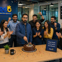 Hireo team celebrating success with founder cutting cake in office, employees clapping in modern workspace